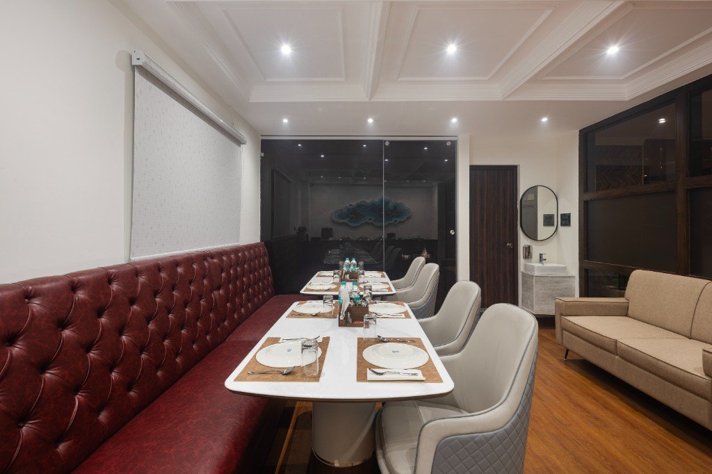 Elysium Premier Suites, Hitec City — Marble tables and tufted bench