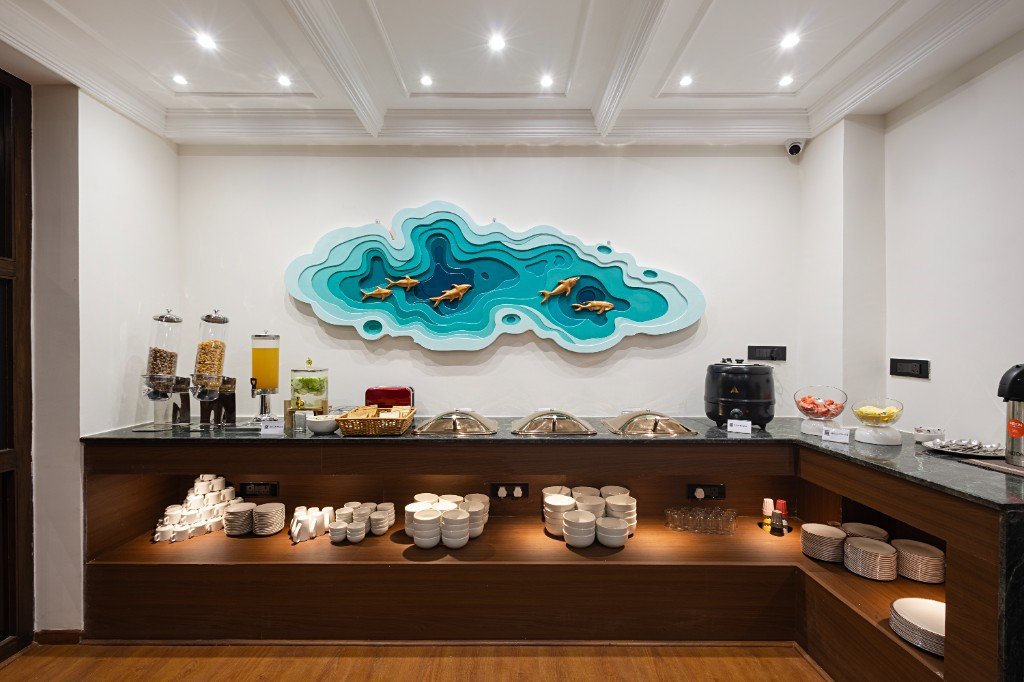 Elysium Premier Suites, Hitec City — Buffet counter and wall art