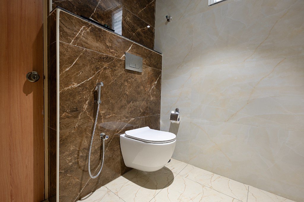 Elysium Premier Suites, Hitec City — Marble washroom with wall-hung toilet